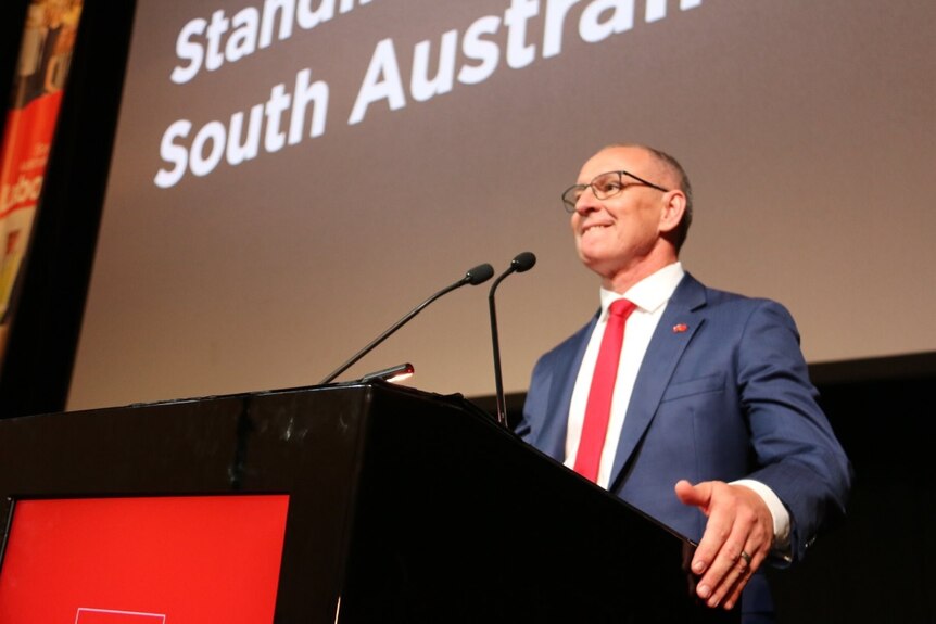 Jay Weatherill stands at a podium.