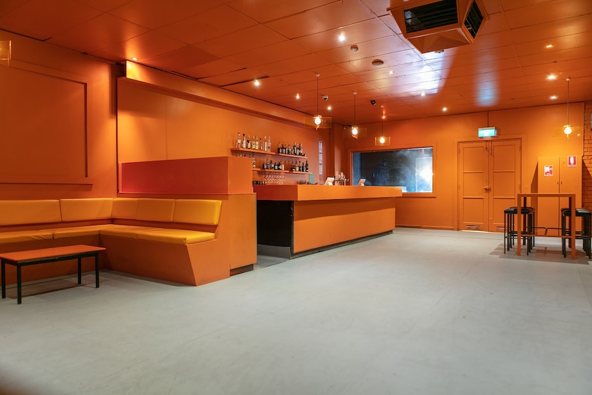 An interior shot of one of the bars in Carlton's Colour nightclub painted bright orange.