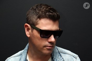 Jolyon Petch wearing sunglasses and a denim jacket