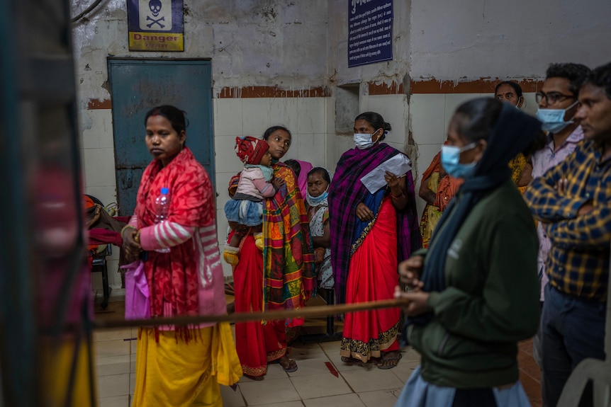 Patients line up to wait for doctors inside a government run hospital in Ambikapur