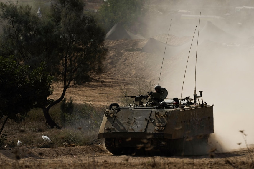 An Israeli armoured personnel carrier (APC) moves near the Gaza Strip border.