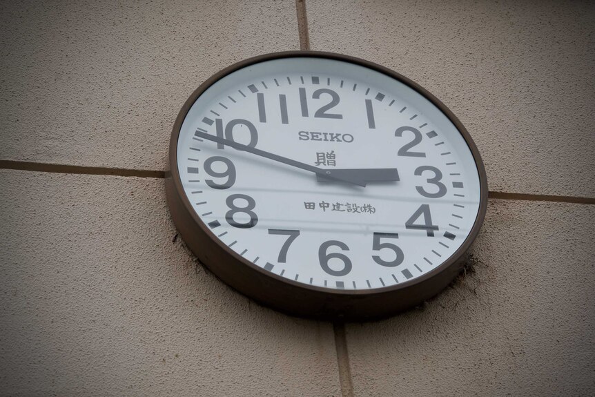 A clock reading 2:48 on a wall