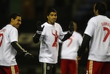 Suarez warming up with team-mates wearing special shirts