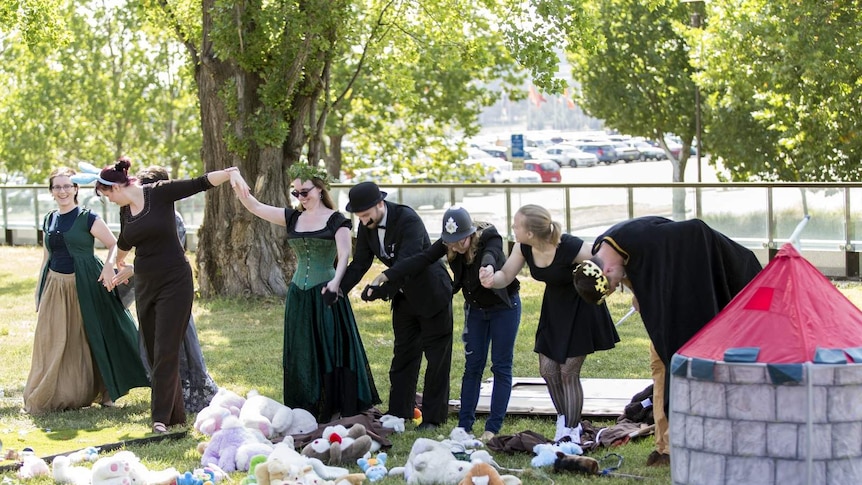 Canberra Library Tribe members take a bow after their performance of Rapunzel outside the National Library.