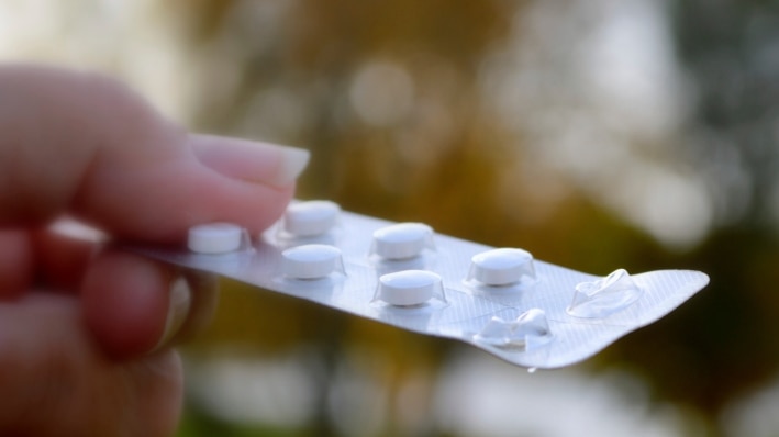 Someone holding a packet of tablets in a blisterpack