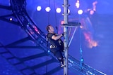 Captain Luke Sinnott climbs the flagpole to hang the Union Flag during the closing ceremony.