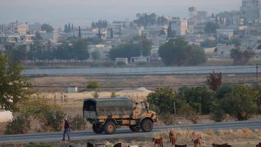 A Turkish military truck in Syria patrolling a road