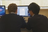 High school students using a computer to surf internet
