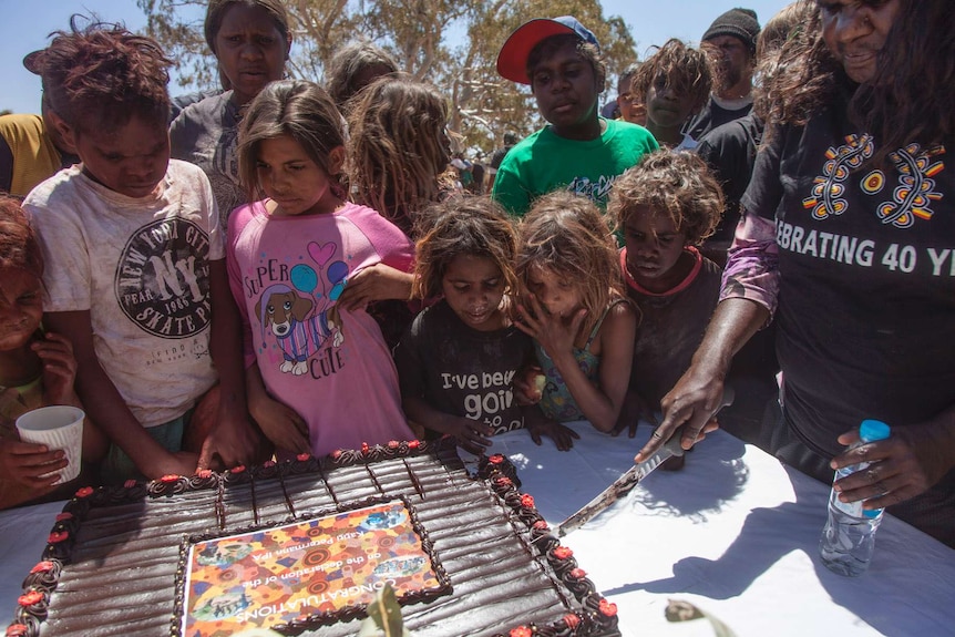 People in the small community of Tjitjingati celebrate the signing of the IPA with a cake