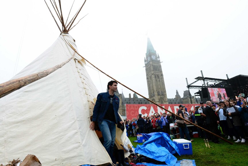 Crowds watch as Prime Minister Justin Trudeau leaves a teepee on Parliament Hill in Ottawa.