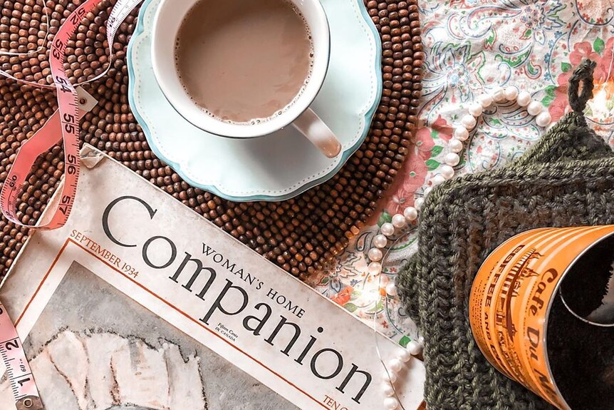 A cup of tea, measuring tape and a copy of Woman's Home Companion sits on Danielle's coffee table.