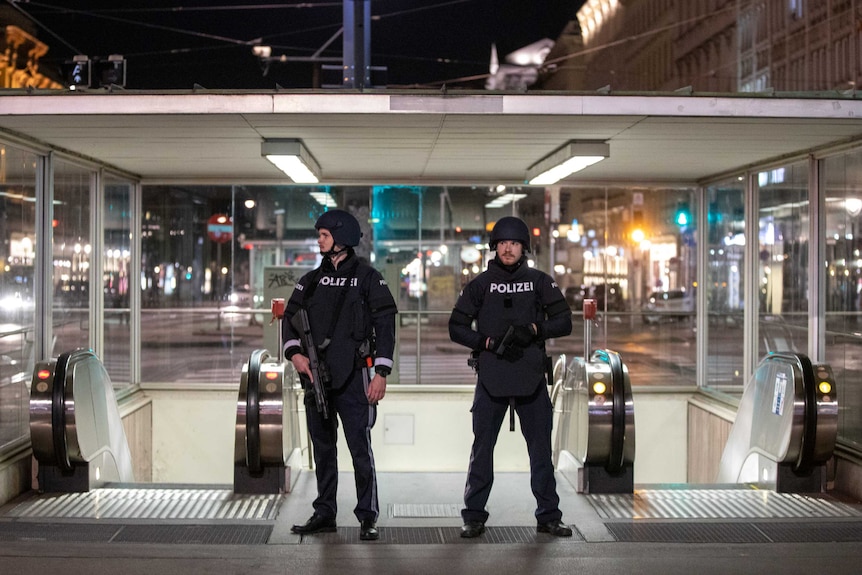 Police guard the entrance to a subway station outside the iconic Vienna Opera