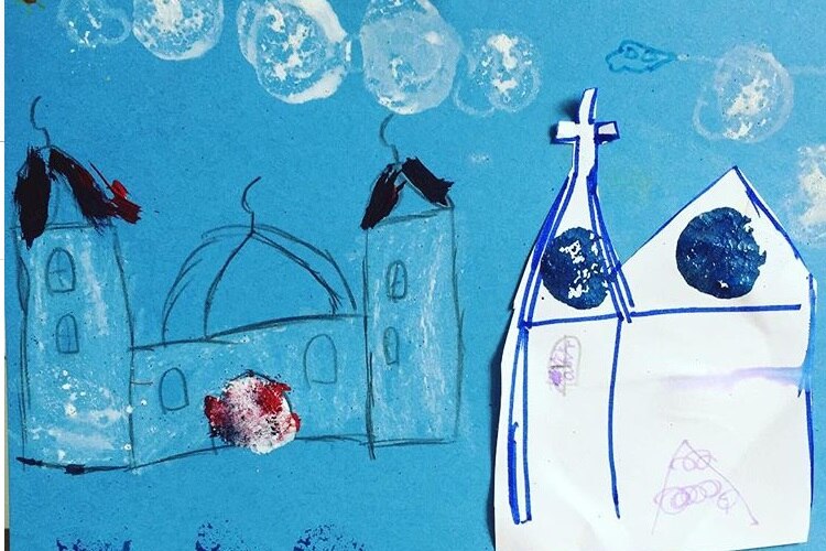 child's art work for a mosque and a church next to each other
