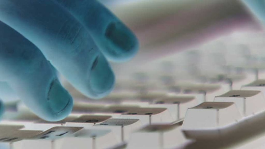 Man's fingers on computer keyboard