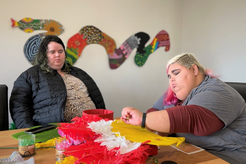 Two women do crafts at a table