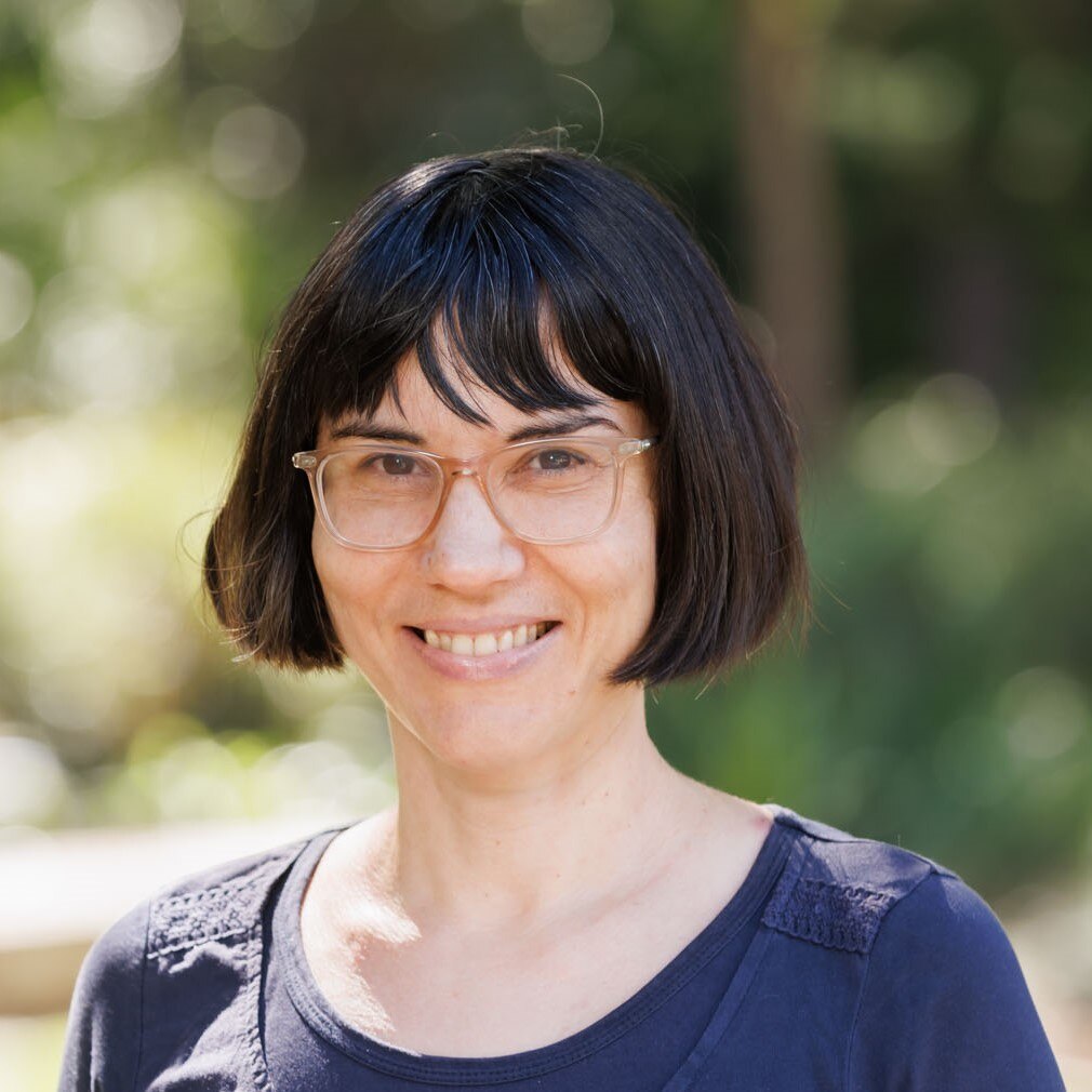 A headshot of a smiling woman.