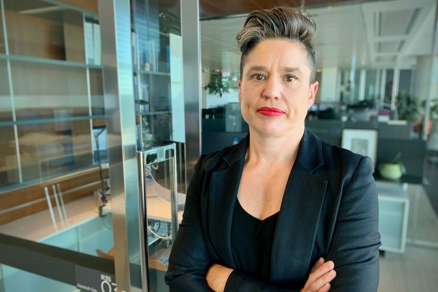 A woman dressed in a suit in an office environment