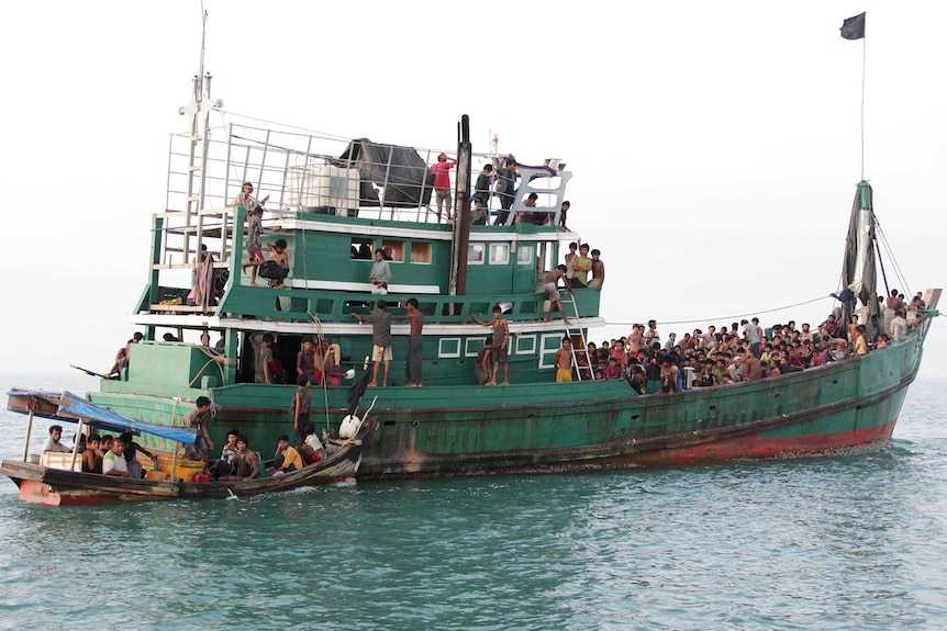 Indonesian fishermen help Rohingya migrants adrift off the coast of Aceh