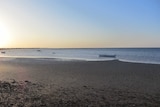 A beach scene at dawn or dusk.