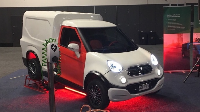 A white van with a red door parked in a warehouse