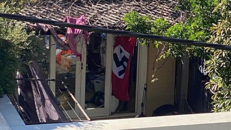a nazi flag hanging behind a door