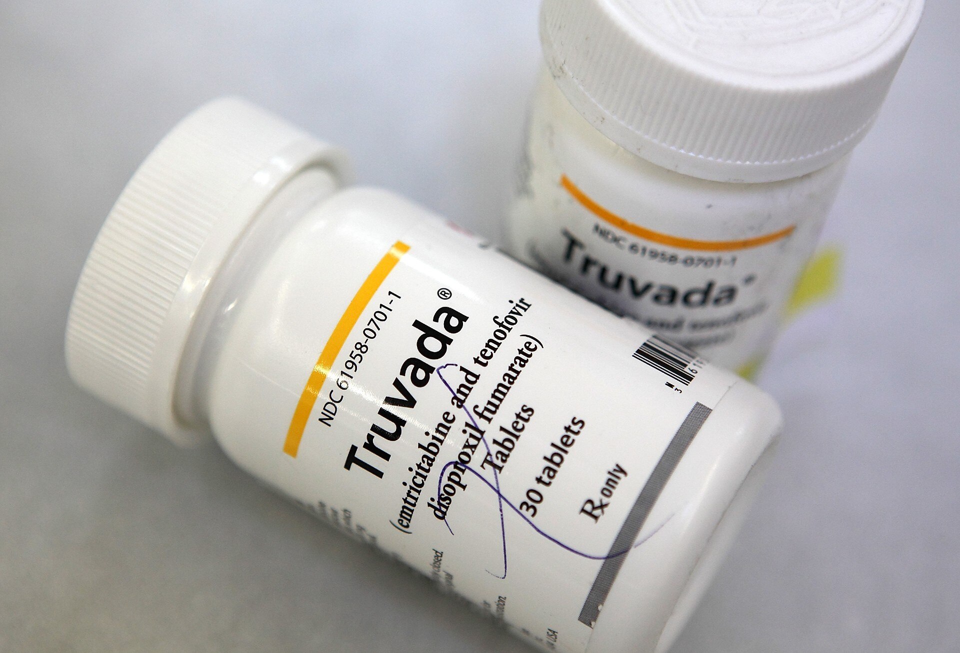 Two medication bottles with Truvada on the label