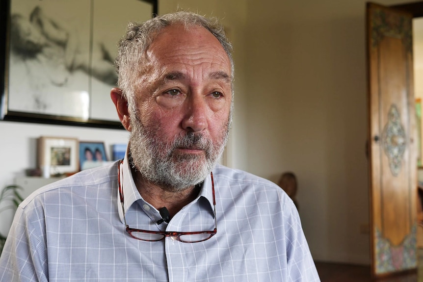 A man wearing a blue check shirt.