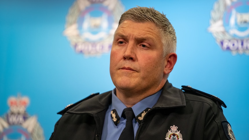 WA Police commissioner Col Blanch wears a uniform and speaks in front of a police background. 