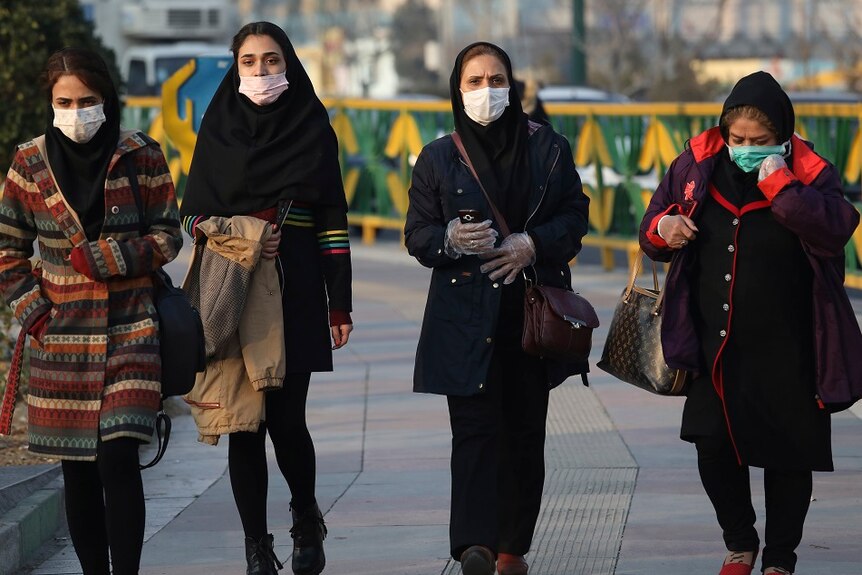 Four women wearing face masks.