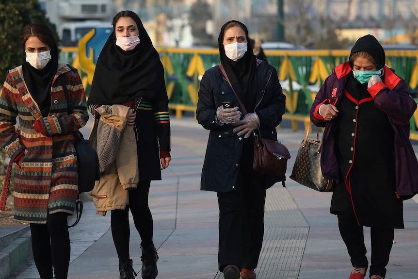 Four women wearing face masks.