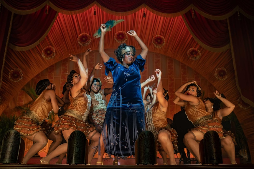 A scene from Ma Rainey's Black Bottom with Viola Davis on stage performing surrounded by dancers all in flapper outfits