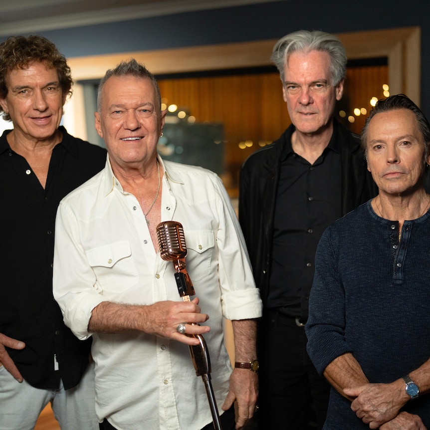 Four members of the band Cold Chisel photographed in a studio in 2024