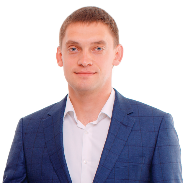 Mayor Ivan Fedorov smiles as he sits in front of a plain white background.