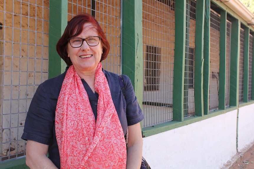 Michelle Murch outside the white and green house