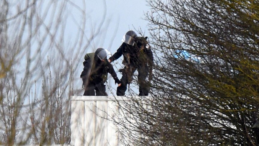 Police take up a position on a roof in Dammartin-en-Goele