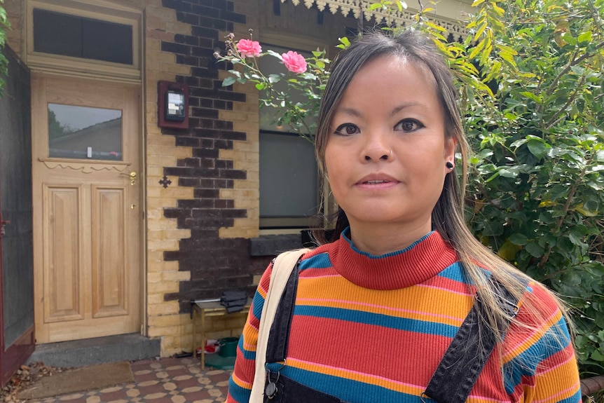 Ari Yeung stands outside her rental home.