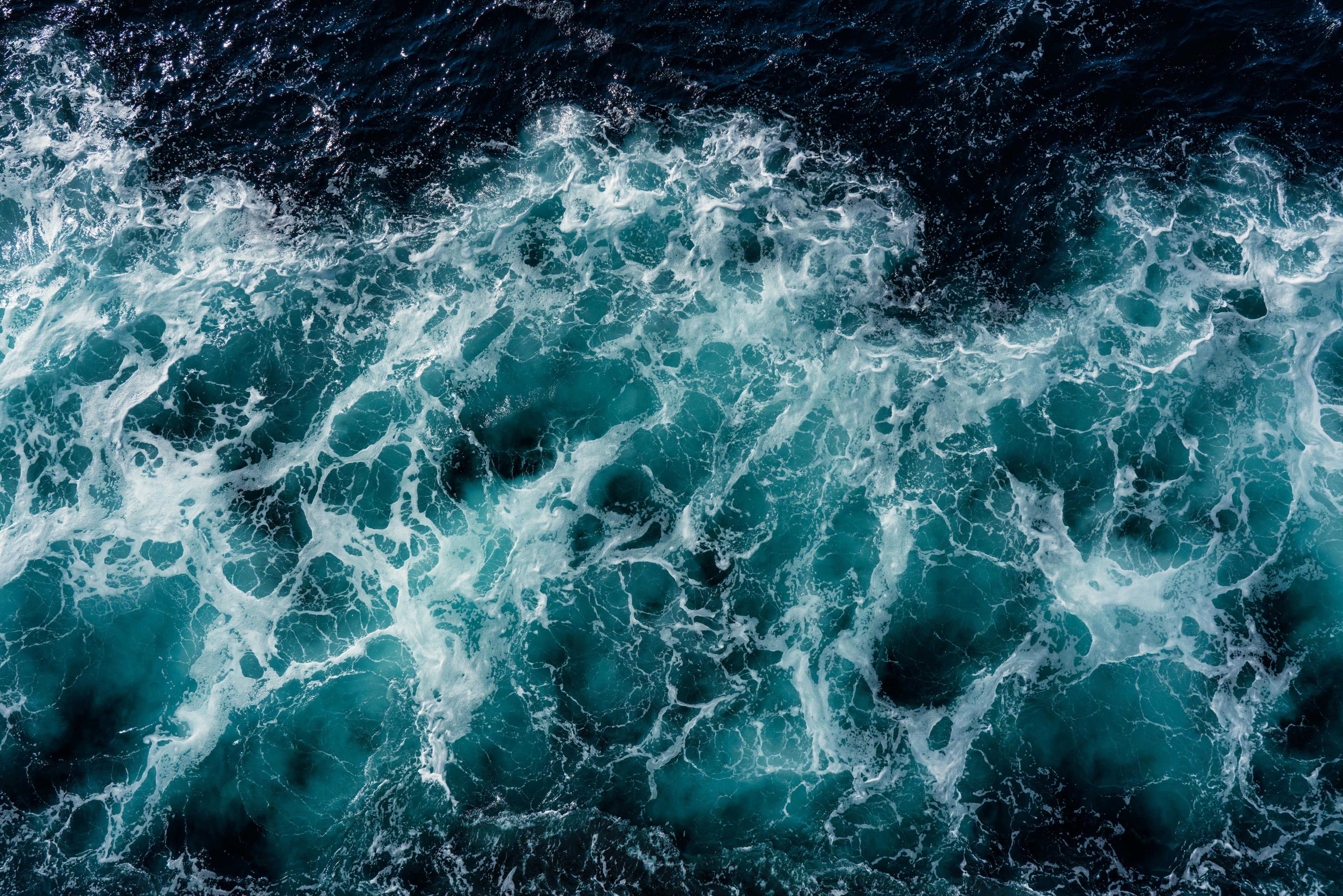 Aerial image of a dark and stormy ocean.
