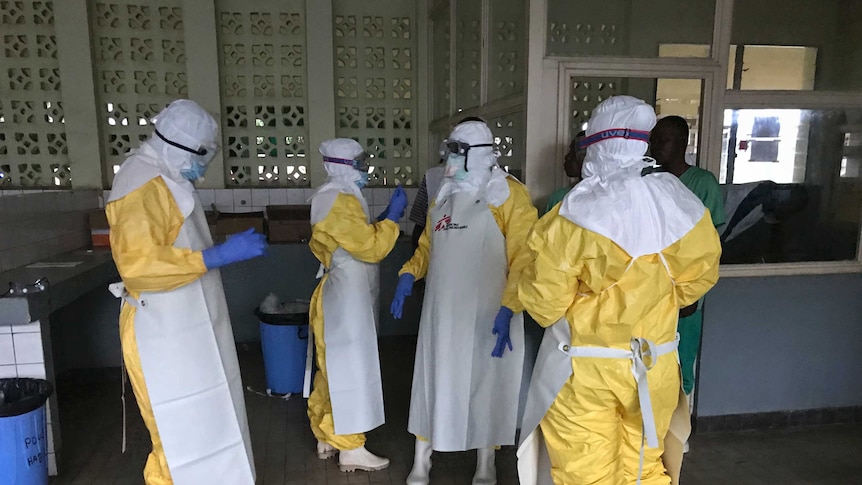 Health workers in yellow Hazmat suits