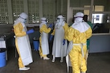 Health workers in yellow Hazmat suits