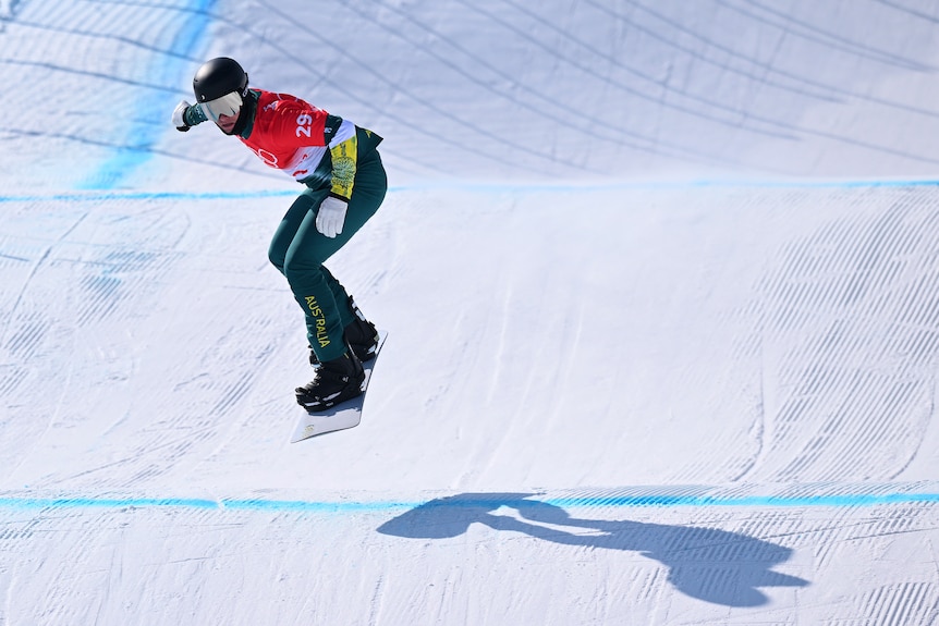 An Australian competes in the men's snowboard cross event at the Beijing Winter Olympics.