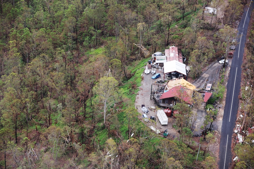 An aerial shot shows a home pulled apart by storms