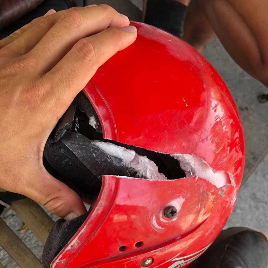 A red helmet with a large split.