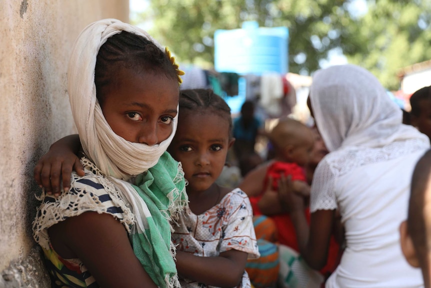 Refugees from the Tigray region of Ethiopia region wait to register with the UN