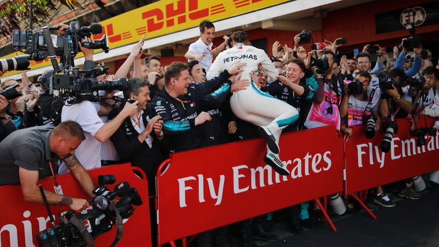 Mercedes driver Lewis Hamilton of Britain celebrates after winning the Spanish F1 Grand Prix.