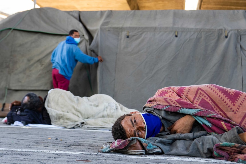 A homeless man sleeps at a homeless shelter in Cape Town, South Africa, Sunday March 29, 202