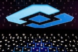 The blue diamond-shaped logo of Russia's state communications regulator, Roskomnadzor, is reflected in a laptop screen