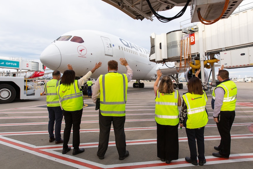 Qantas staff welcome the first international flights 