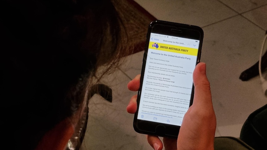 An email from the United Australia Party can be seen on a mobile phone screen.