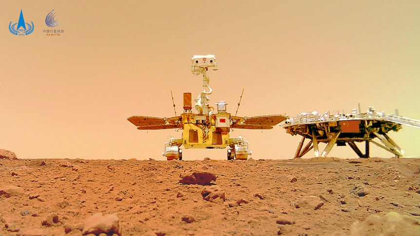 A photo of a dusty, rocky Martian surface and a Chinese rover and lander together has been released by the China National Space Administration, with 