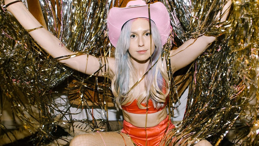 Freya Josephine Hollick surrounded by tinsel and wearing a pink cowboy hat